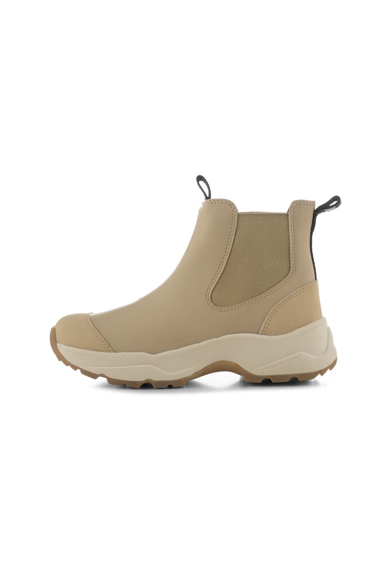 Botas de tobillo impermeables beige con paneles laterales elásticos, parte superior texturizada y suela de goma. Incluye lengüetas en la parte posterior para ponerlas y quitarlas fácilmente.
