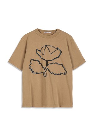 T-shirt beige à manches courtes avec un grand motif pixelisé noir de rose et de feuilles sur le devant.