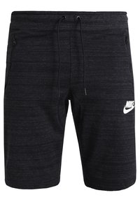 Shorts de sport noirs Nike avec ceinture à cordon, poches latérales zippées et logo Nike blanc sur la cuisse gauche.