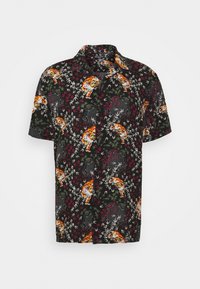 Camicia a maniche corte con sfondo nero e vivaci motivi di tigri e fogliame in tonalità di arancione, verde e rosso.