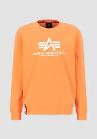 Orangenes Sweatshirt aus Baumwolle mit Rippbündchen. Verfügt über ein weißes Logo und Akzente, einen runden Halsausschnitt und ein kleines rotes Etikett am Saum.