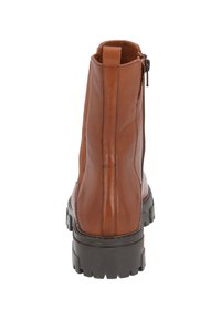 Botines de cuero marrón con un acabado suave, paneles laterales elásticos, cremallera trasera y suela de goma negra gruesa para mayor tracción.