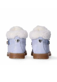 Lichtblauwe laarzen met fake fur voering, decoratieve hartvormige hardware en gestructureerde bruine zolen. Accenten zijn onder andere glinsterende details.