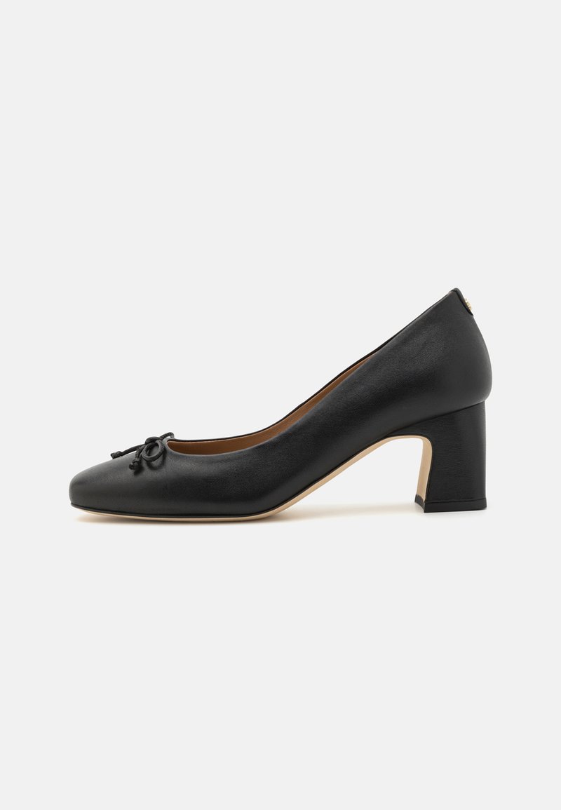 Black leather pump with a rounded toe, featuring a bow detail on the front. Chunky heel with a smooth finish and a contrasting beige sole.