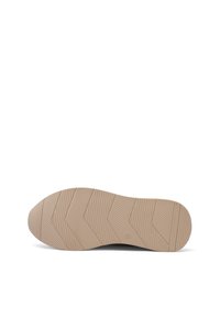 Suola delle scarpe in gomma beige con una grip intagliata; presenta dettagli a zigzag e texture per una maggiore aderenza. Forma piatta e arrotondata.