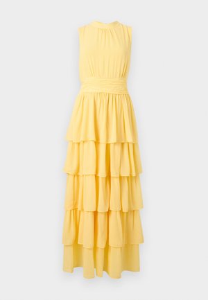 Ärmelloses gelbes Maxikleid mit mehrstufigem Rüschensaum und tailliertem Bund, vor schlichtem hellem Hintergrund präsentiert.