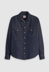 Mörkblå denimskjorta med knappstängning fram, två bröstfickor och vita detaljer. Har en krage och en rundad nederkant.