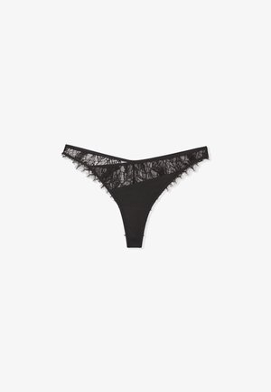 Perizoma nero con dettagli in pizzo lungo l'elastico e le gambe, caratterizzato da un corpo in tessuto liscio e un design minimalista.