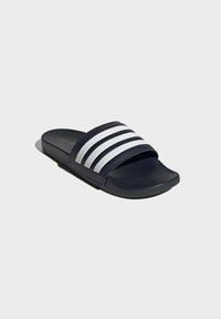 Dark blue slide sandal with a wide upper strap featuring three white horizontal stripes. Smooth texture and flat rubber sole for comfort.