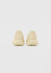 Lime green and yellow athletic shoes with a textured sole, smooth upper, and rear accents in a slightly darker shade.