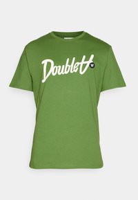 Green cotton t-shirt featuring a white script logo "Doublet" on the front, crew neckline, and short sleeves with a relaxed fit.