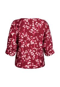 Marooni paita valkoisilla ja vaaleanpunaisilla kukkakuoseilla, jossa on rento istuvuus, puffihihat ja pyöreä kaula-aukko. Pehmeä, kevyt kangas.