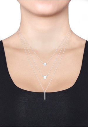 Silberne geschichtete Halsketten mit einem kleinen runden Anhänger, einem dreieckigen Charm und einem vertikalen Balkenanhänger an feinen Ketten. Elegantes und minimalistisches Design.