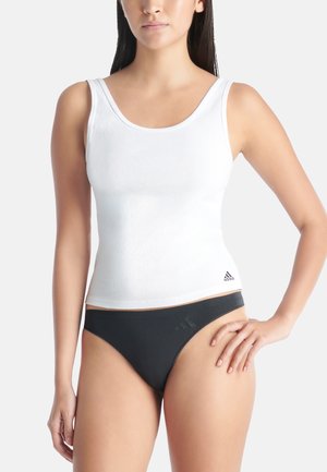 White ribbed tank top with wide straps and a fitted design. Black low-rise bikini bottom. Both items feature the Adidas logo.