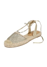 Espadrille tejida en oro y beige con suela de yute trenzado, parte trasera abierta y lazos de cinta. Parte superior texturizada con hilos metálicos y plantilla contorneada.