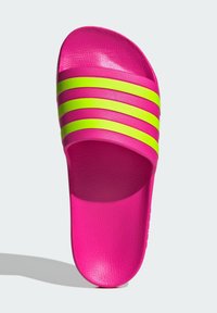 Pink slide sandal with textured design; features three horizontal neon green stripes across the upper. Flat sole, casual style.