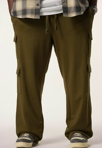 Olijfgroene cargobroek van zacht materiaal, met zijzakken, een rechte pasvorm en een relaxte fit, gecombineerd met grijze sneakers.