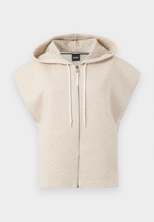 Béžová bezrukávová mikina na zip s vzorovanou podšívkou kapuce, tkanicemi a malým logem na hrudi; měkký, textured materiál.