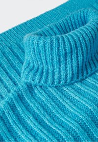Knitted sweater in bright turquoise blue with a ribbed texture. Features a high, folded neck and diagonal ribbing design.