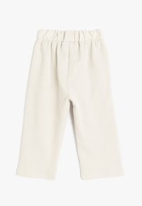 Lys beige ribbede bukser med elastisk talje, lige ben og et struktureret stof, der giver en blød og komfortabel pasform.