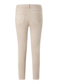 Jeans ajustados beige con una textura suave, diseño de cinco bolsillos y una cinturilla blanda sin herrajes visibles ni adornos.