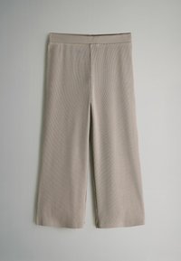 Beige, verkürzte Hosen mit gerippter Textur und elastischem Bund. Sie verfügen über ein gerades Bein mit seitlichen Schlitzen am Saum.