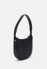 Black leather shoulder bag with a curved shape, zip closure, and a front patch pocket. Features a smooth finish and adjustable strap.