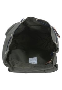 Bolsa de lona verde con un interior espacioso, que cuenta con un bolsillo con cremallera y un cierre de cordón. Textura suave, herrajes de metal y acentos de cuero.