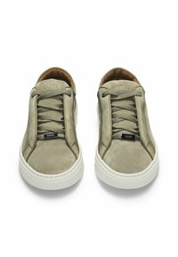Gray suede sneakers with a white rubber sole, featuring laces, a logo tag, and an overall smooth texture. Minimalist design.