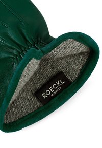 Green leather glove with a soft, grey wool lining. Features a snug fit and a contrasting textured trim. Labels visible inside.