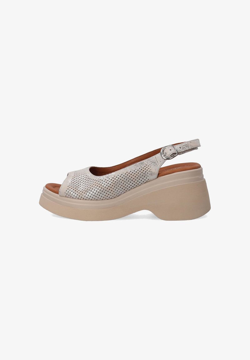 Slingback sandal in metallic silver perforated leather with an open toe, featuring a thick beige platform sole and adjustable strap.