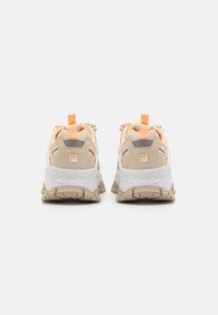 Athletic sneakers with a beige and light orange color scheme. Made from mesh and suede, featuring a chunky sole and heel pull tab.