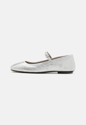 Silver ballet flats with a rounded toe, a single adjustable buckle strap, and a smooth metallic finish. Flat sole, minimalist design.