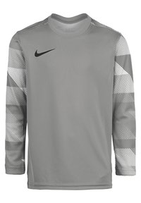 Maglietta da allenamento a maniche lunghe grigia con accenti grigi a righe sulle maniche, con logo Nike nero sul lato sinistro del petto.