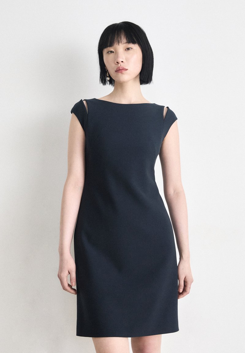 Dark navy bodycon dress with short sleeves, featuring cut-outs on the shoulders. Smooth texture and sleek design enhance the silhouette.