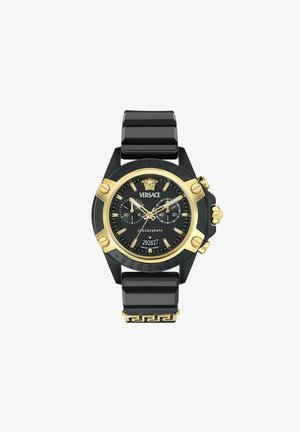 Orologio Versace con cinturino nero e accenti dorati. Presenta un quadrante nero, funzione cronografo e design a chiave greca sul cinturino.