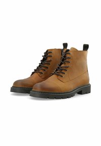Bottes de cheville en cuir marron avec un bout rond, un laçage sur le devant et des semelles en caoutchouc noir. Elles présentent une bordure cousue et deux tirettes.