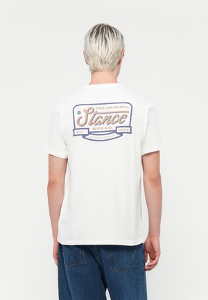 White cotton t-shirt featuring a colorful graphic on the back, with rounded neckline and short sleeves, displayed on a neutral background.