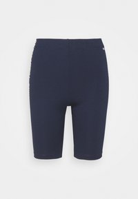 Marinblå stretch-cykelshorts med en figurnära design, med hög midja och logodetaljer på sidorna. Mjuk och slät textur.