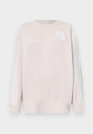 Ανοιχτό ροζ φούτερ με μακριά μανίκι α, λευκή φλοράλ εφαρμογή στο στήθος και τρεις λευκές ρίγες κατά μήκος κάθε μανικιού. Μαλακή υφή υφάσματος.