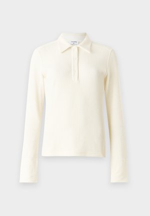 Cream ribbed long-sleeve polo shirt with a collar and three-button placket. Features fitted cuffs and a soft, textured fabric.