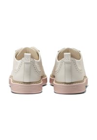 Scarpe in pelle bianca con dettagli perforati, suola a righe rosa e una linguetta sul tallone. Il design presenta una parte superiore testurizzata.