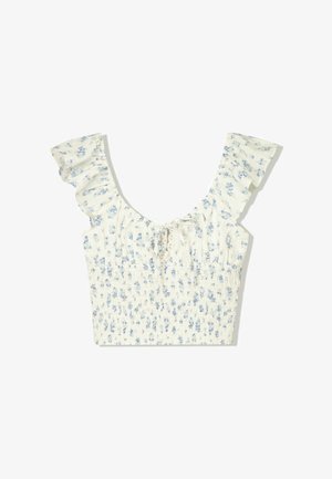 Hvid blomster crop top med blå mønstre, har flæser på ærmerne og en smocket bodice. Justerbar snore-detalje ved halsudskæringen.