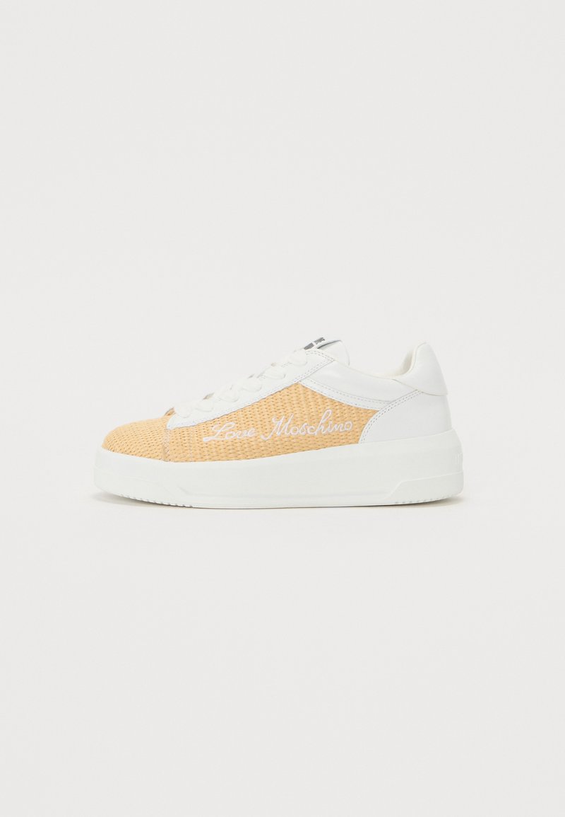 Orange mesh upper with white leather accents, featuring white branding. Thick white rubber sole, lace-up design, and rounded toe.