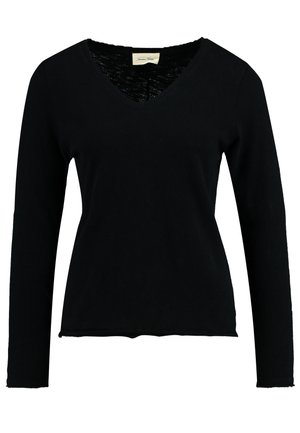 Haut noir à manches longues et col en V en tissu doux. Présente une coupe décontractée avec un ourlet légèrement effiloché et un col intérieur texturé.
