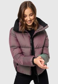 Puffer jacket featuring a purple and green iridescent finish, black collar, and front zipper. Textured fabric with padded sections.