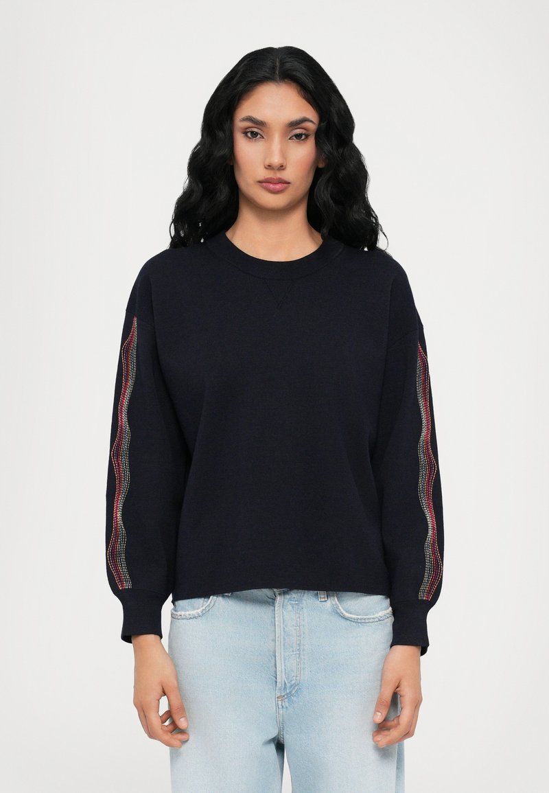 Navy sweatshirt with long, patterned sleeves featuring a colorful stripe detail. Soft fabric, relaxed fit, round neckline, and ribbed cuffs.