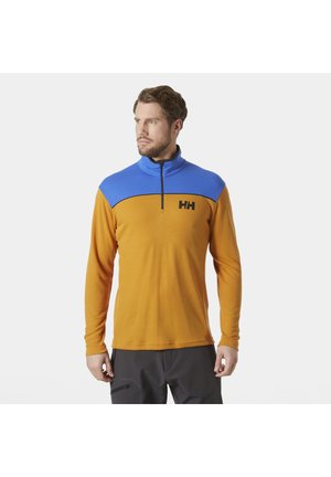 Langsleeve pullover in oranje met een blauwe halve ritssluiting op de kraag. Bevat een zwart logo op de borst en heeft een aansluitend ontwerp. Gladde textuur.