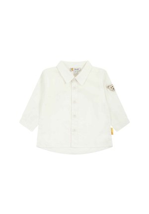 Camicia bianca a maniche lunghe con colletto, apertura con bottoni e ricamo di un orso sulla manica sinistra. Materiale in cotone morbido, vestibilità casual.