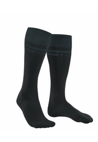Calze nere fino al ginocchio realizzate in un materiale elastico, con un branding sottile e righe a contrasto nella parte superiore. Texture complessivamente liscia.